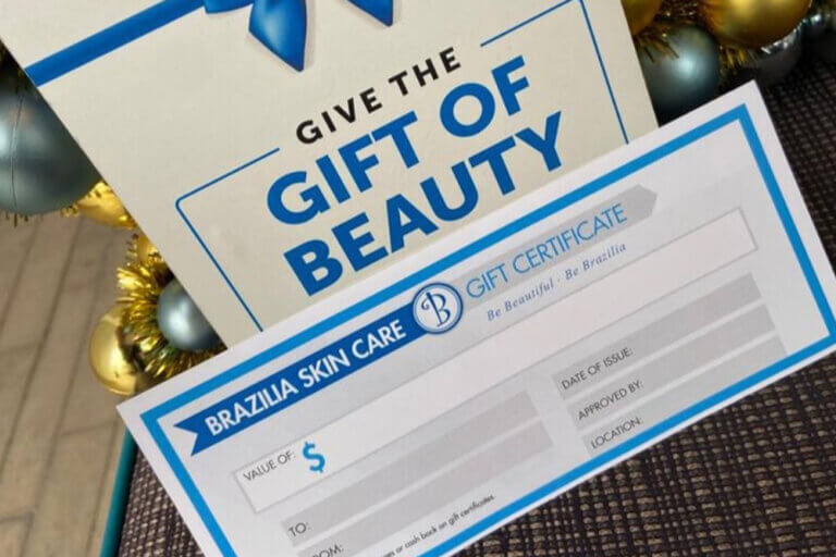A Brazilia gift certificate. A sign behind reads Give the Gift of Beauty