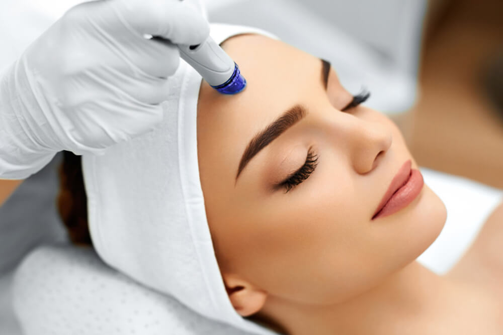 Woman at spa getting hydrafacial service