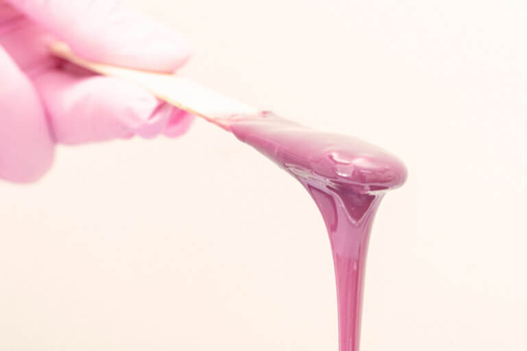 Pink wax on a popsicle stick