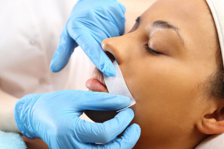 Woman getting her upper lip waxed