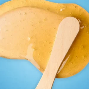 orange wax and a wood stick