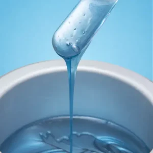 blue wax dripping into a wax pot